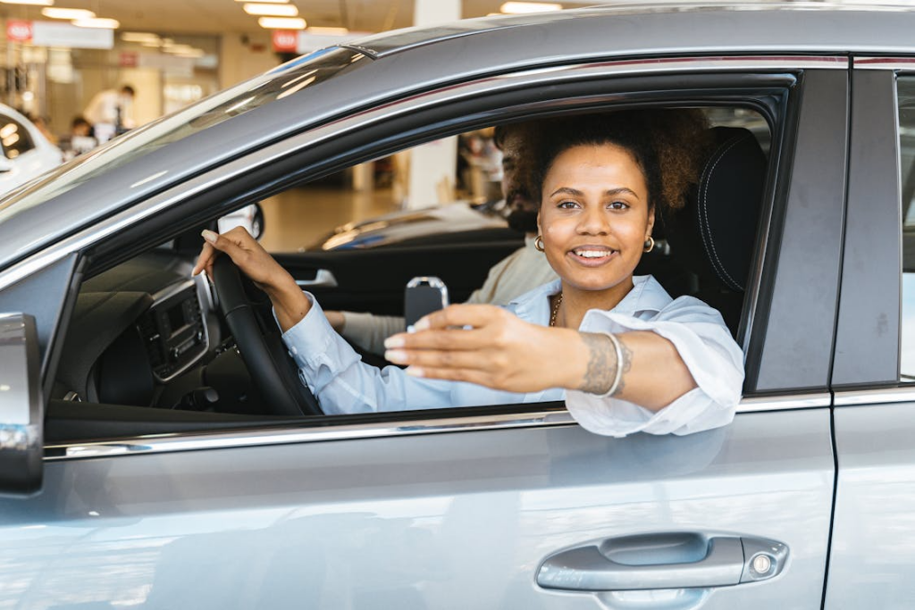 Woman holding car keys during courtesy vehicle handover at auto glass service center