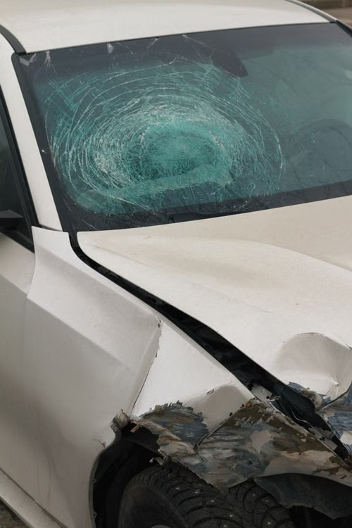 Close-up of severely cracked and damaged car windshield